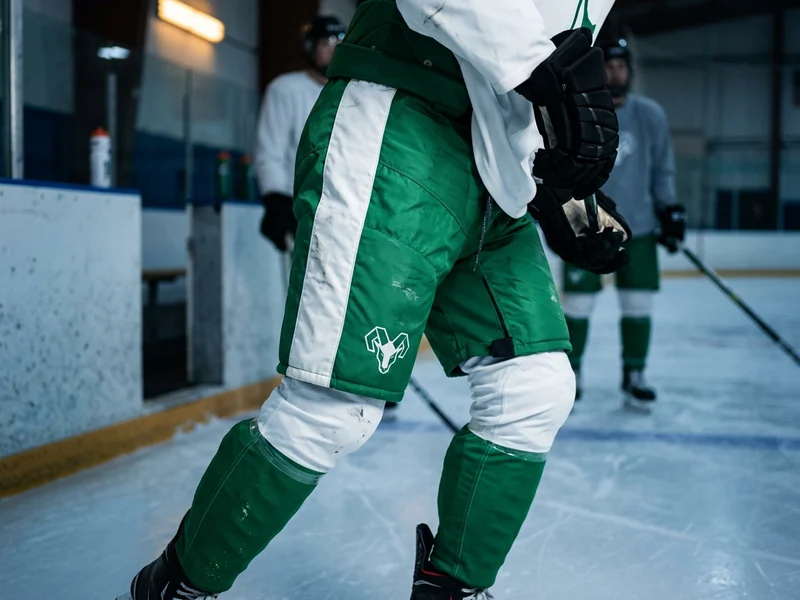 Game pant shells in a kelly green and white fictional team colorway worn on the ice during play